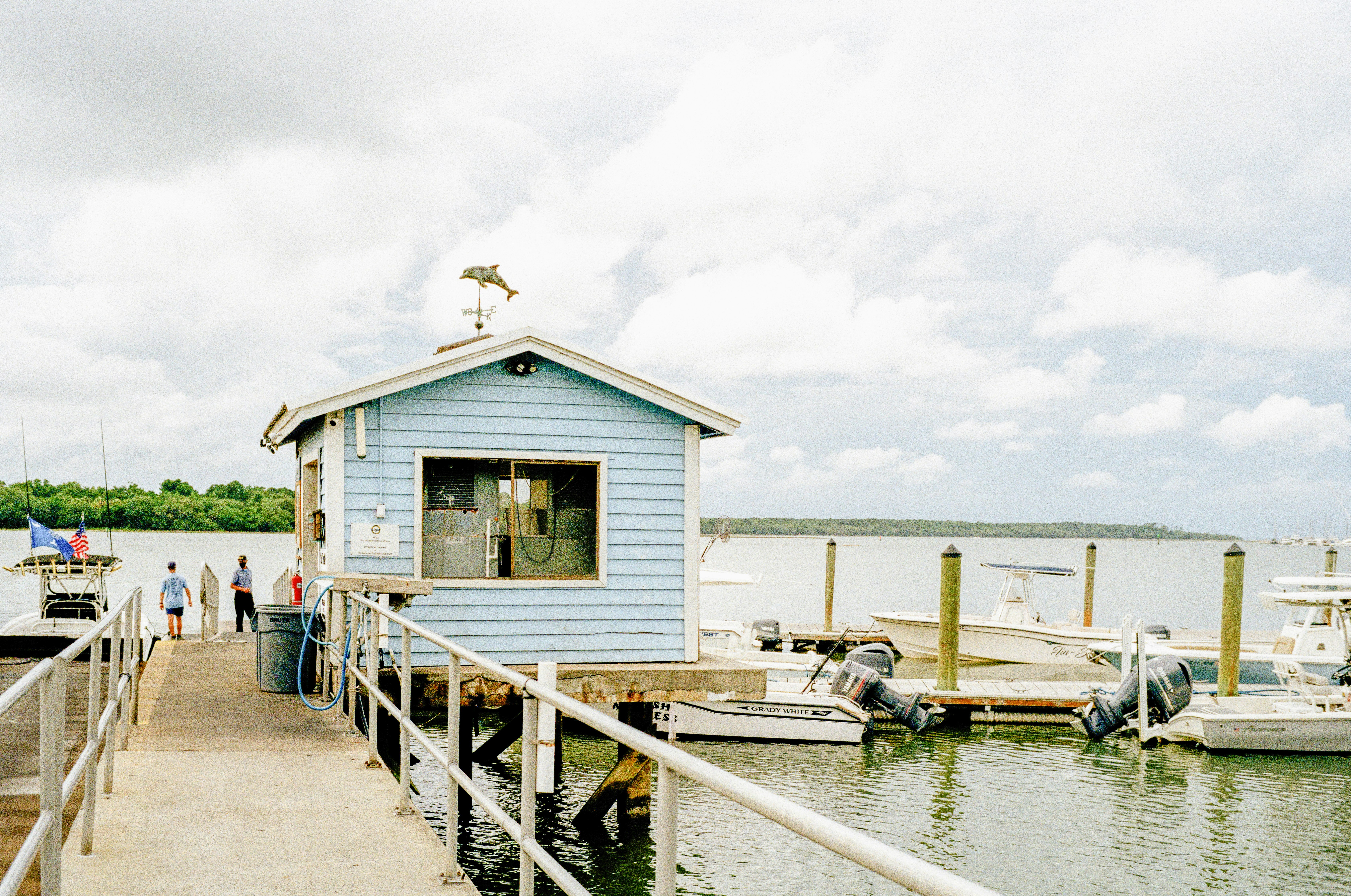 white and brown wooden house on dock during daytime